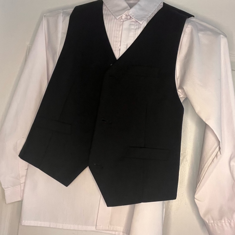 Boys white tuxedo shirt black vest and pants.